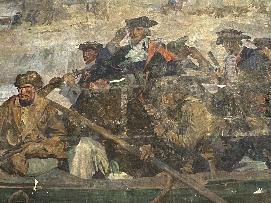 A close-up of George Washington in a painting of him crossing the Delaware.