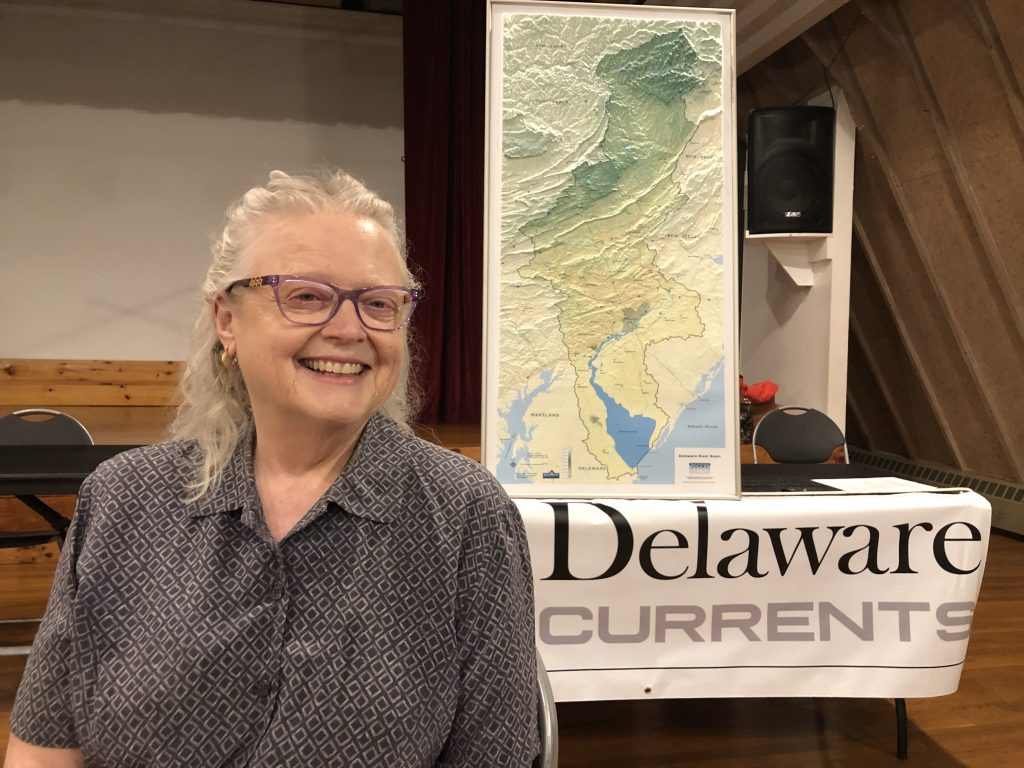 Woman in front of map of Delaware watershed