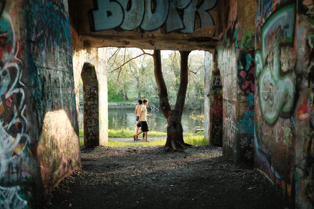 Two pier visitors take the trail out of Graffiti Pier after spending the afternoon fishing. Photo by Adam Litchkofski 
