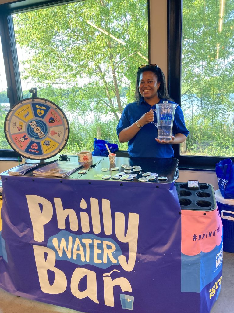 Jennifer Ailey, community outreach associate with the Philadelphia Water Department, serves tap water at the Philly Water Bar. Photo by Angelique Bacha