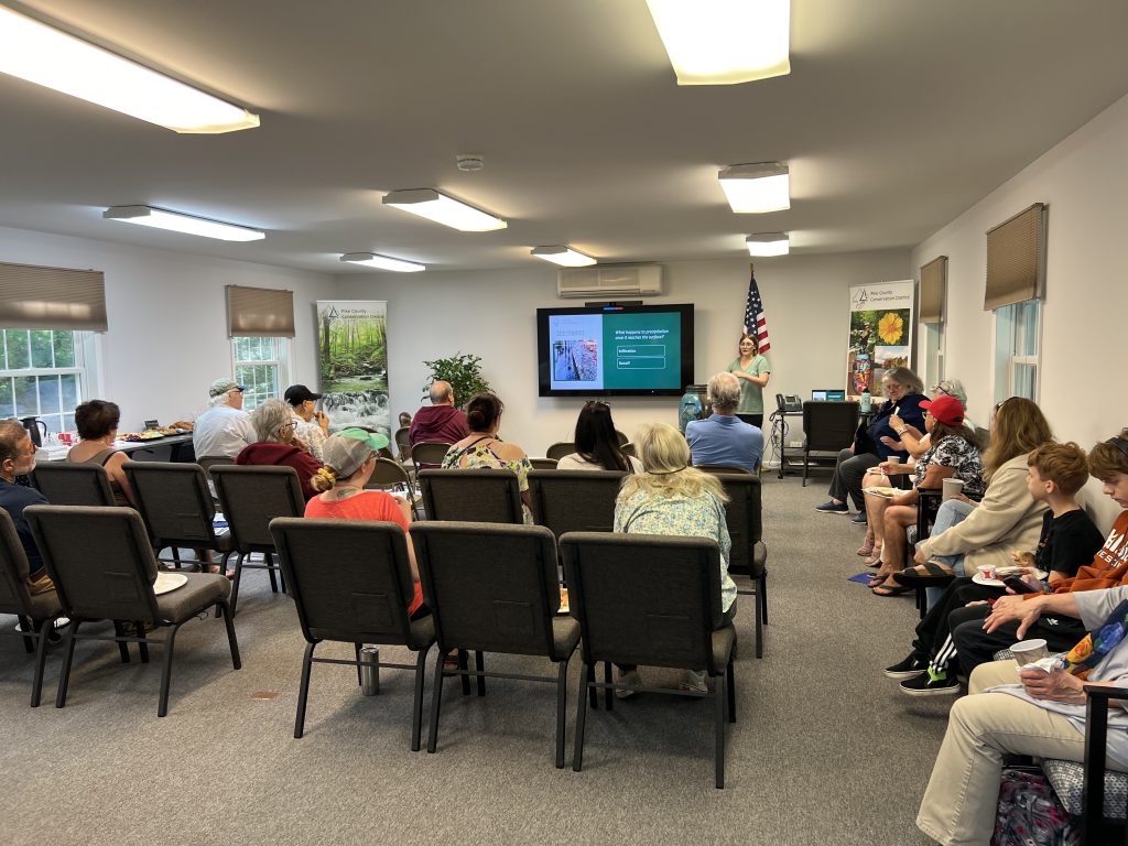 Group of people listening to presentation.