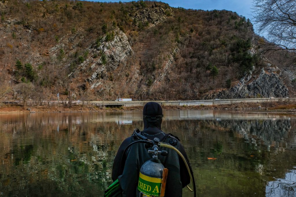 Diver Brett Galambos surveys the dive location on the Delaware River. Photo by Preston Ehrler