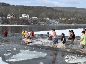 bunch of peaple running into the river