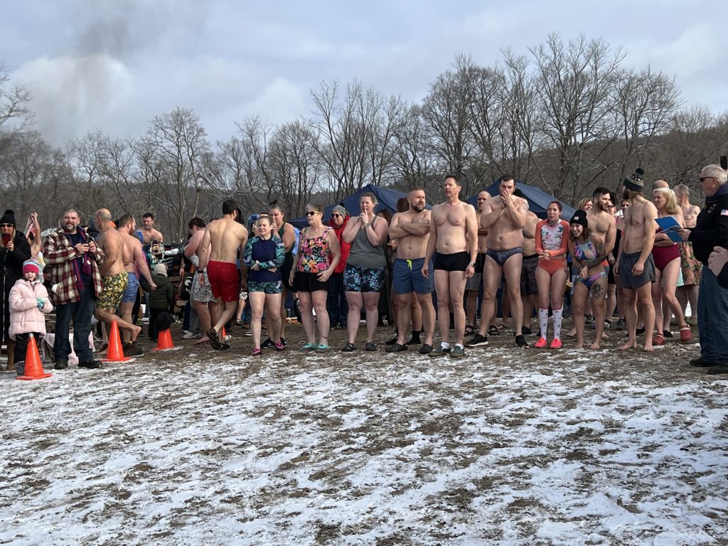 Bunch of people waiting to run into the river