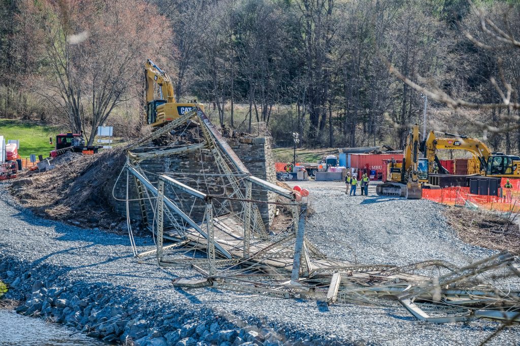 skinners_falls_comes_down0043 The New York side of the Skinners Falls Bridge came down with a knock from an excavator on Thursday. Photo by Preston Ehrler