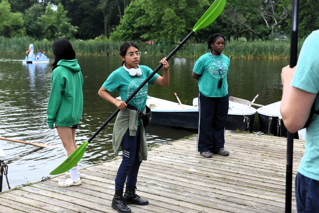 Girl demonstrating how to paddle a kayak