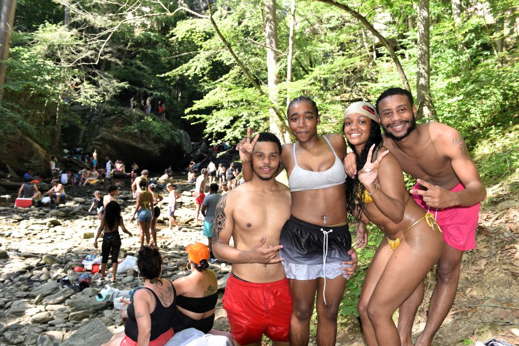 Friends visiting a swimming hole.