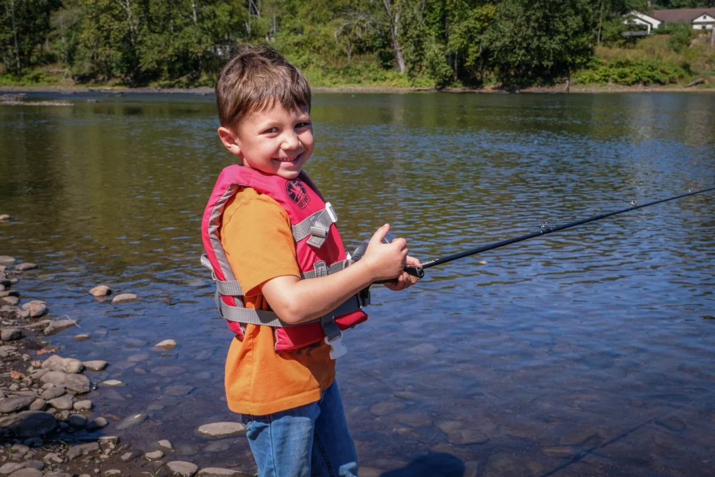 Cash Kozokas, 5, tries his hand at casting a line at last month's fishing clinic. Photo by Preston Ehrler