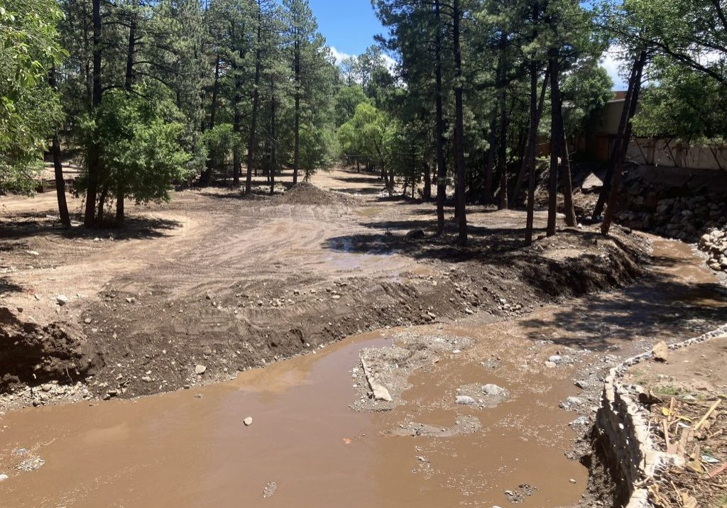 The Rio Ruidoso runs through Ruidoso, New Mexico on Saturday, July 19. Debris has been cleared from some areas along the river after deadly flash floods on July 8. Credit: Martha Pskowski/Inside Climate News