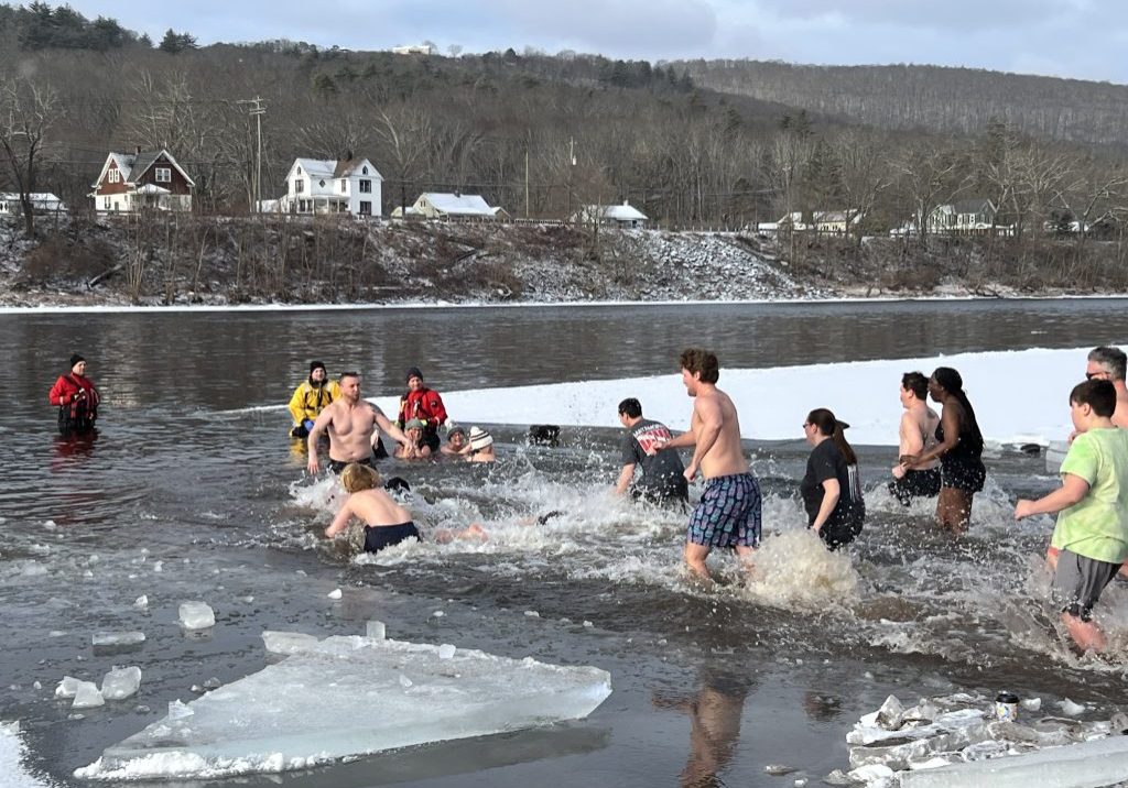 bunch of peaple running into the river