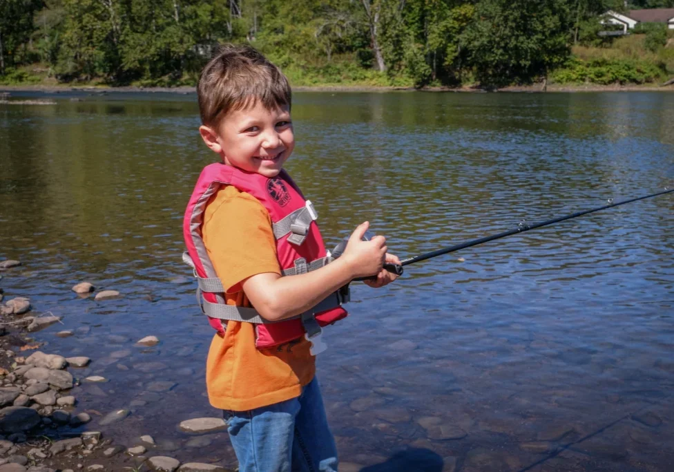 Cash Kozokas, 5, tries his hand at casting a line at last month's fishing clinic. Photo by Preston Ehrler
