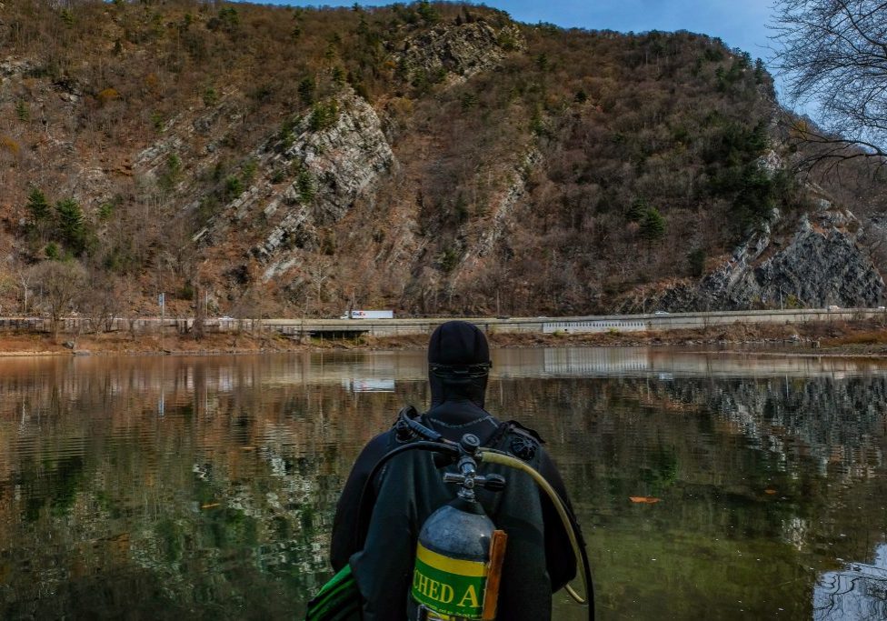 Diver Brett Galambos surveys the dive location on the Delaware River. Photo by Preston Ehrler